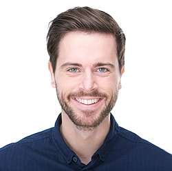 St. Louis Facials model in blue shirt against white background.