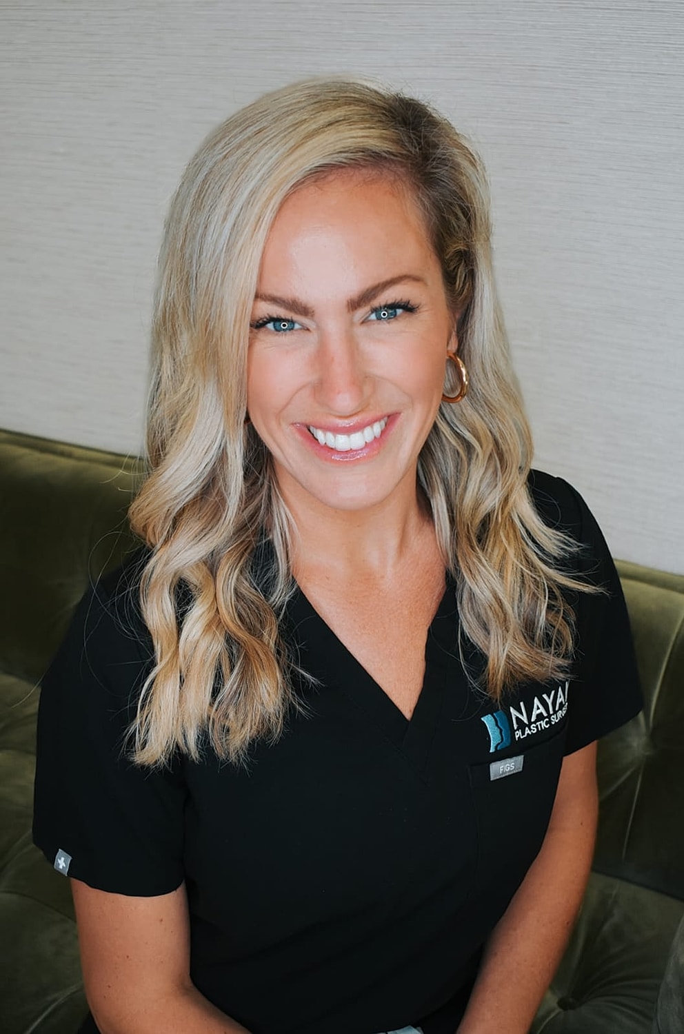 Smiling woman in professional medical attire.
