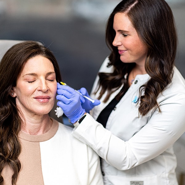 St. Louis Med Spa Medical professional performing aesthetic treatment on patient.