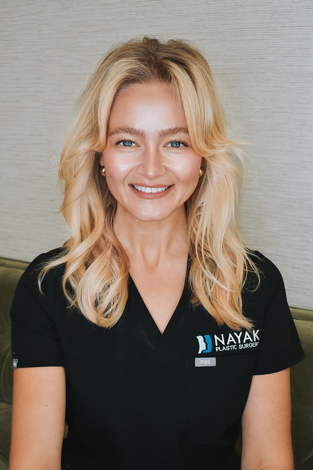 Smiling healthcare professional in medical attire.