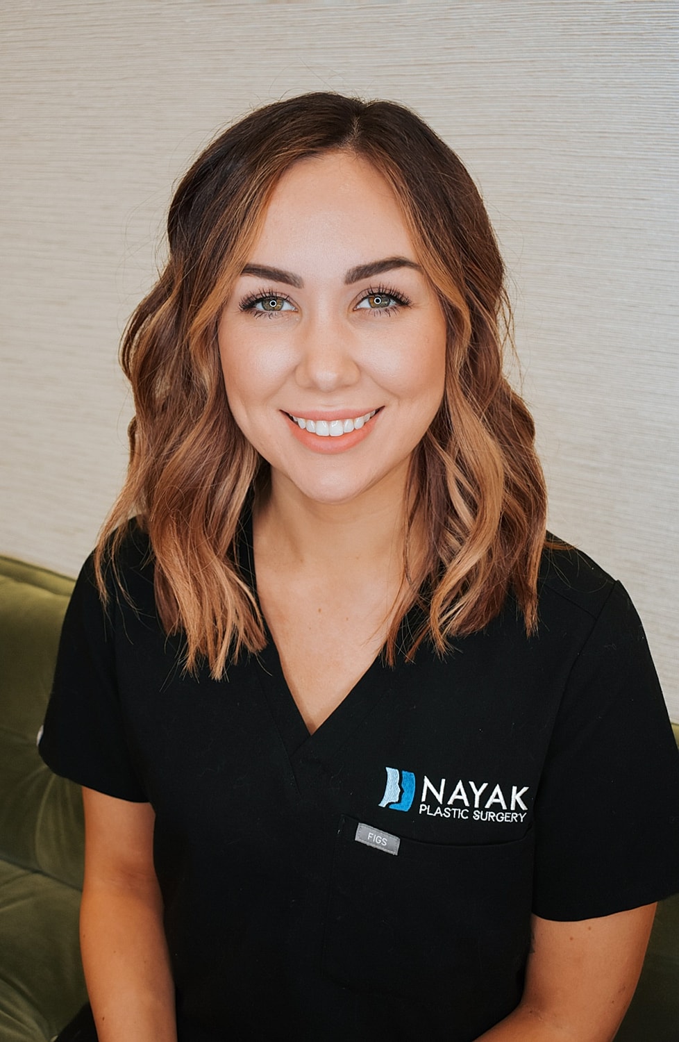 Smiling professional at Nayak Plastic Surgery.