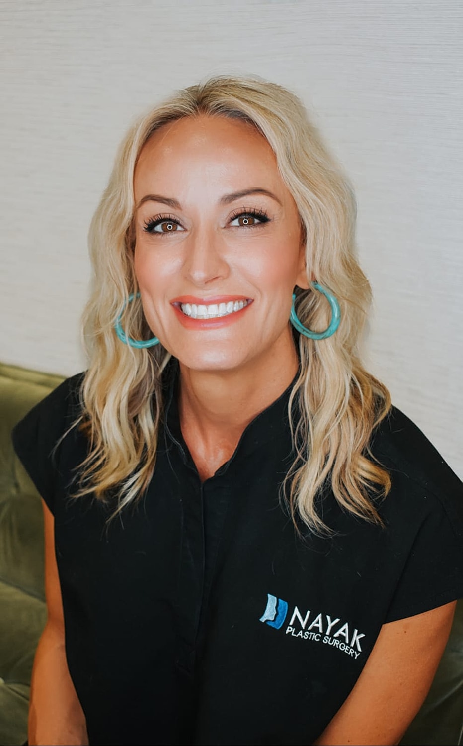 Smiling woman in a plastic surgery clinic.