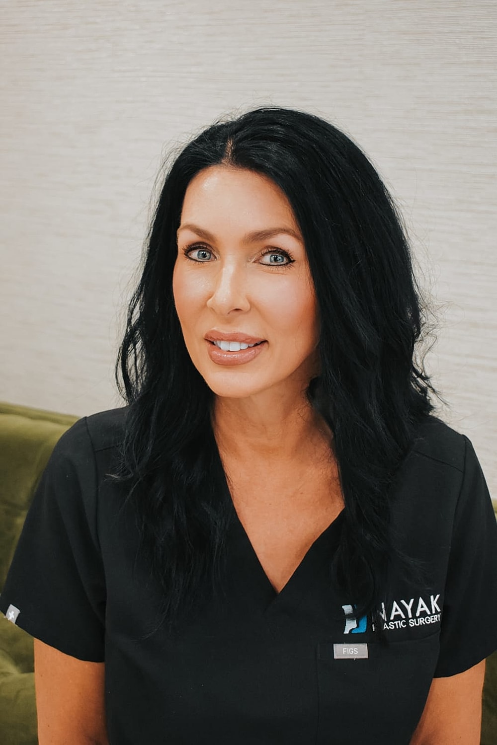 Medical professional in scrubs, smiling.