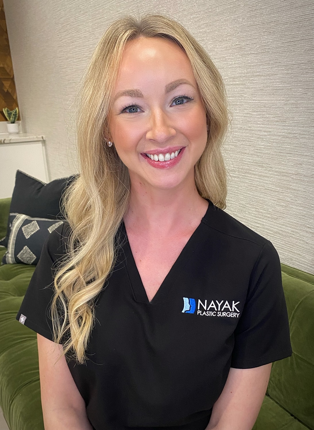 Smiling woman in medical scrub uniform.