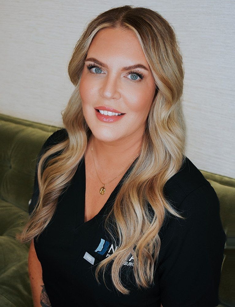 Smiling woman with long blonde hair in uniform.