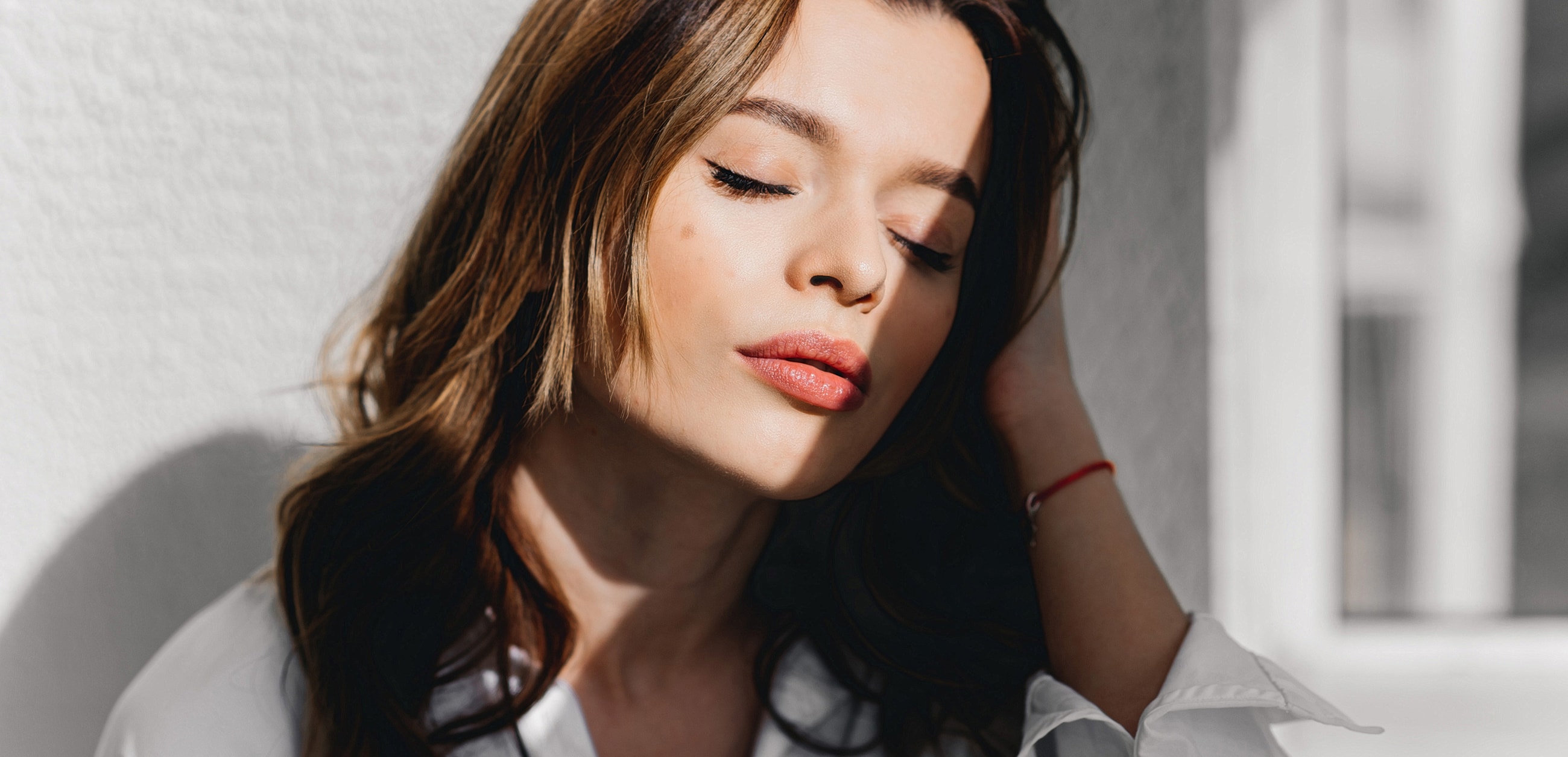 St. Louis Dermal Filler model with closed eyes and soft expression.