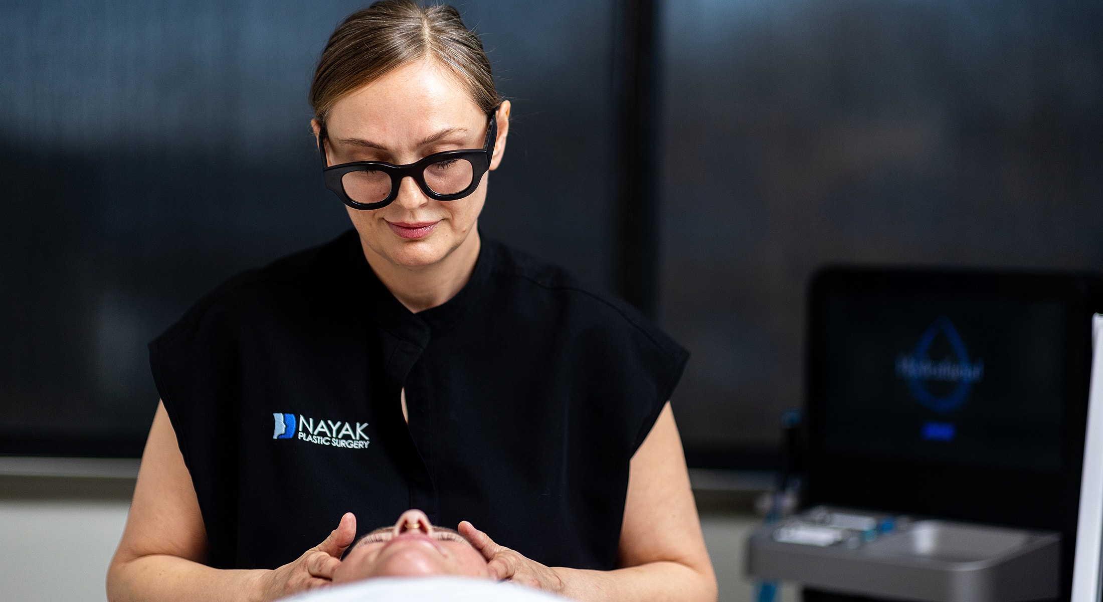 Medical professional at Avani Derm Spa providing skincare treatment.